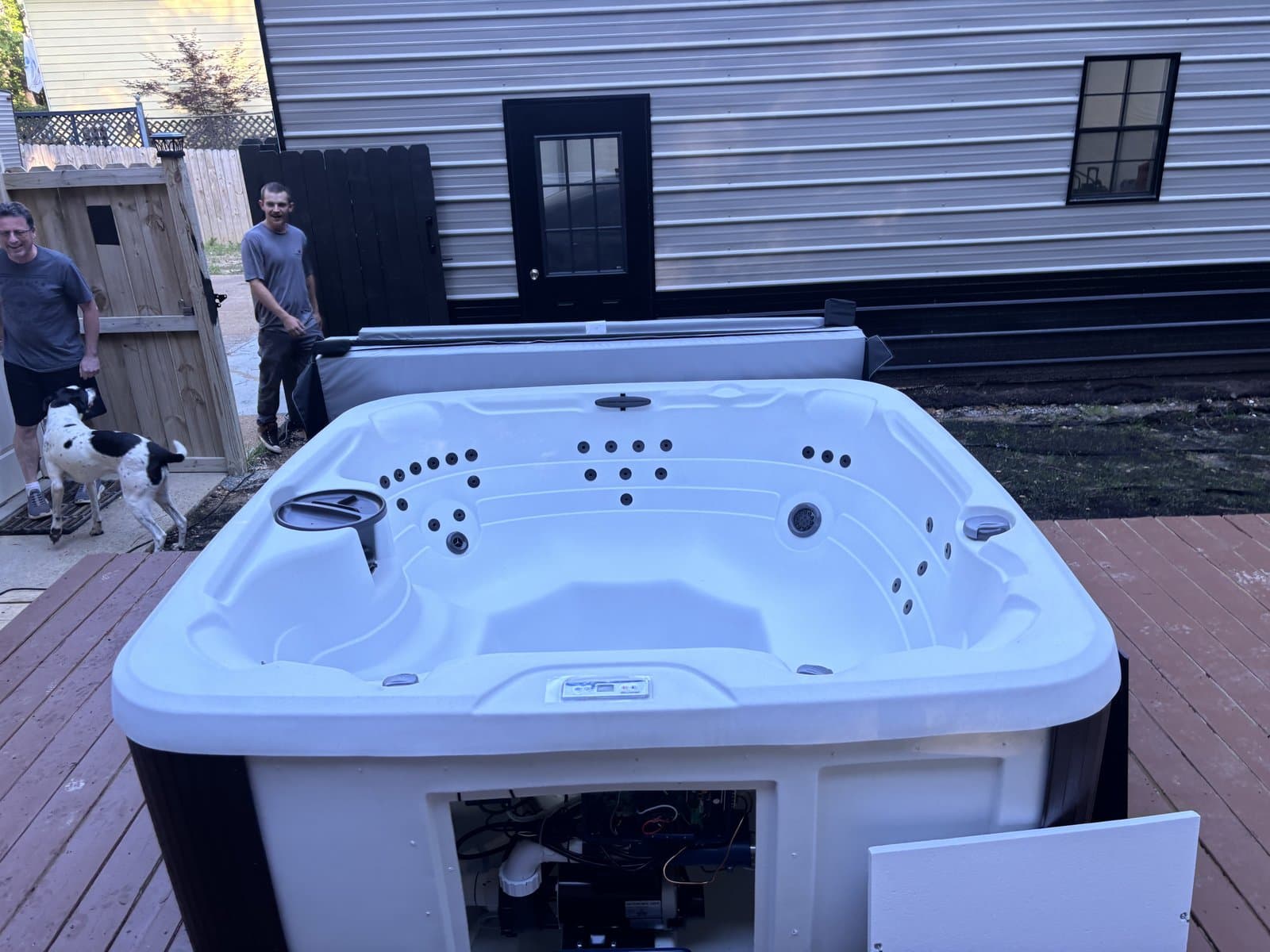 The Platinum crew setting a hot tub in place on a backyard deck