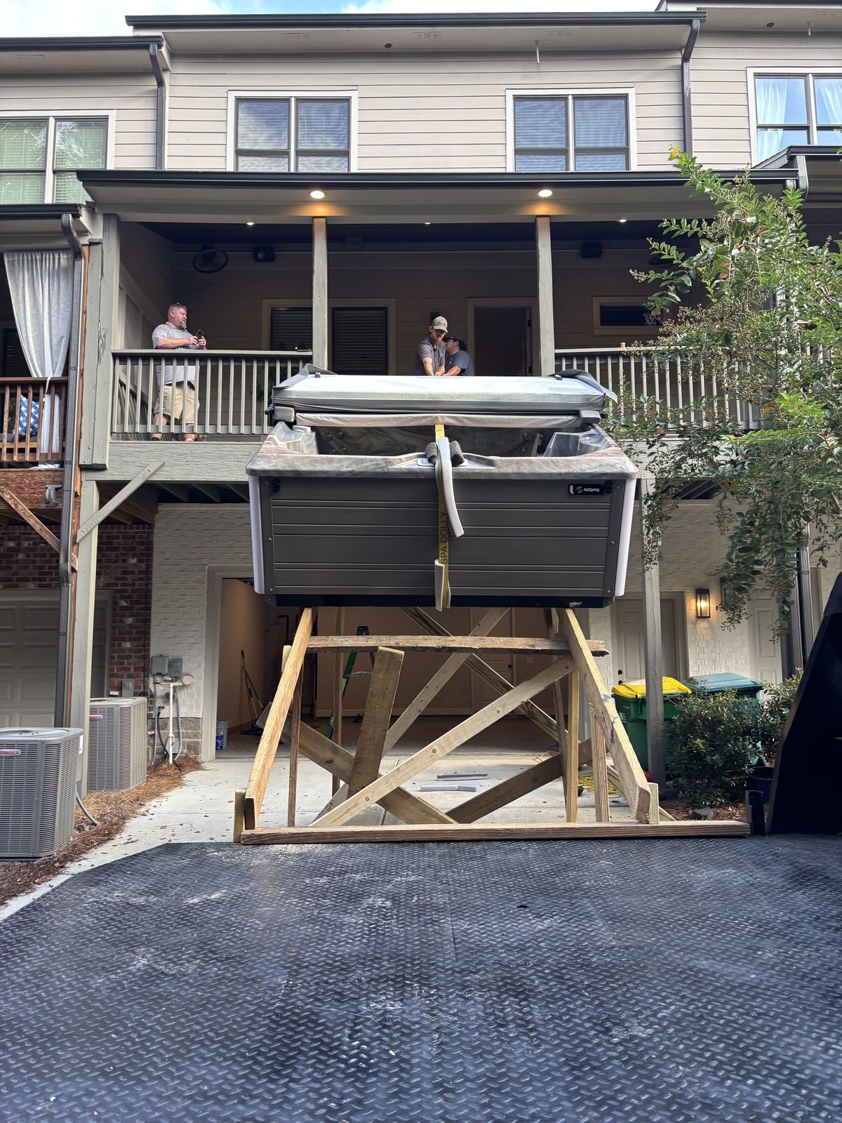 A hot tub raised to second-storey deck height on a timber ramp tower the Platinum crew built on site
